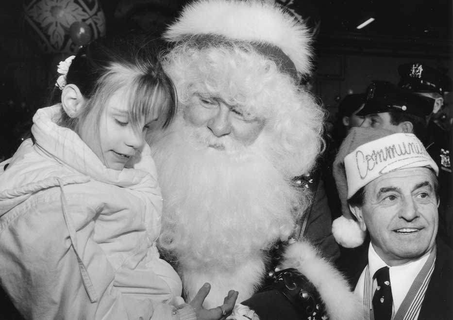 Santa entertaining special needs child with Dominick Della Rocca