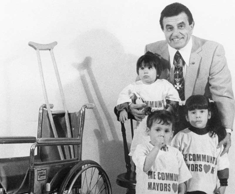 Dominick and his grandchildren wearing Community Mayors shirts