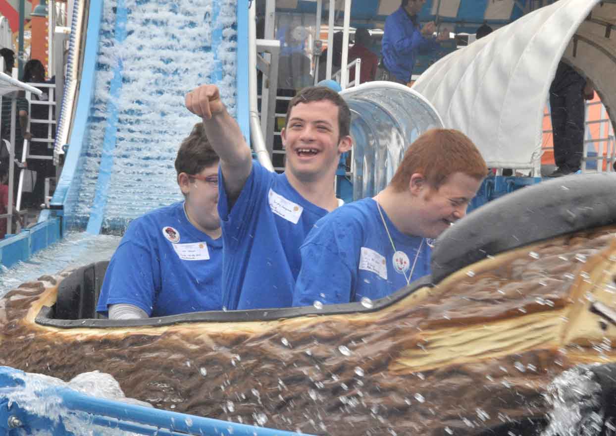Group of teens riding a log flume water ride during a Community Mayors special event