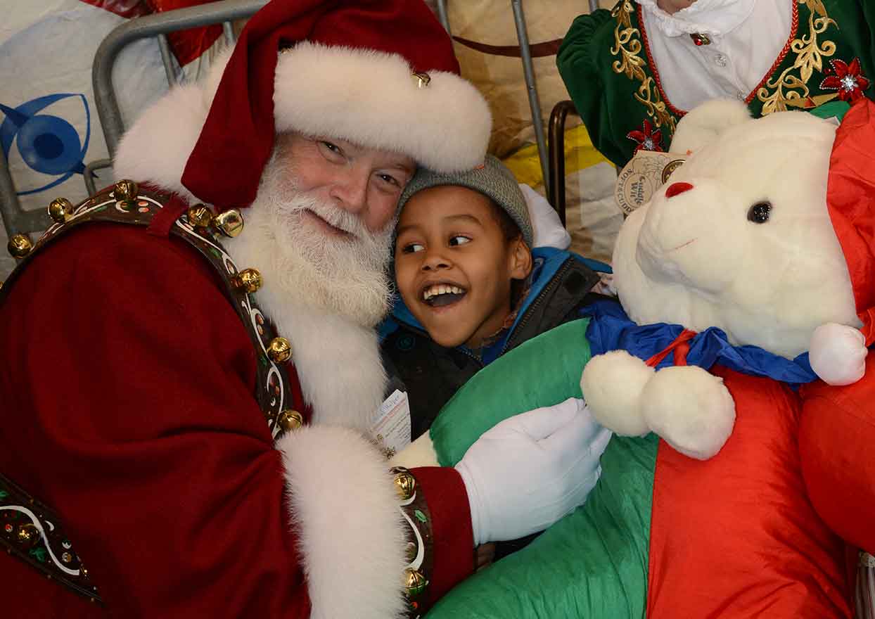 Happy child and Santa Claus at Operation Santa Claus