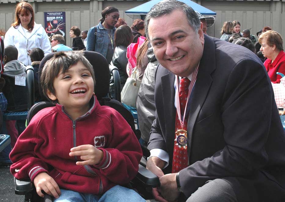 Little boy and Community Mayors volunteer