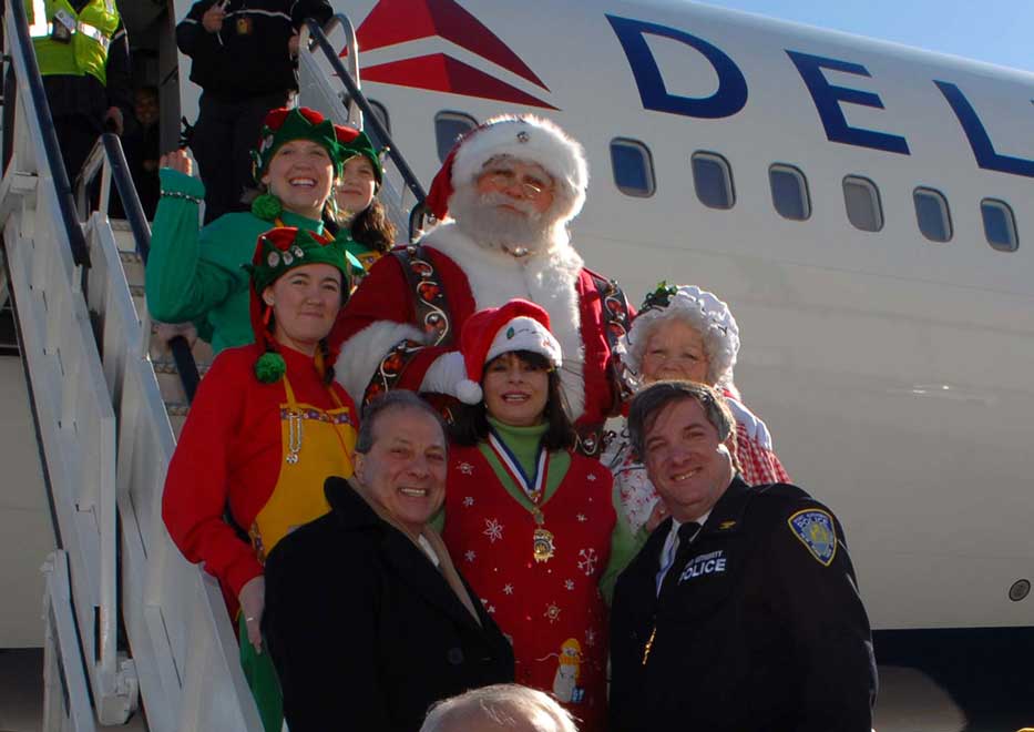 Macy's Santa Claus and Community Mayors exiting Delta Airlines Plane at Operation Santa Claus event