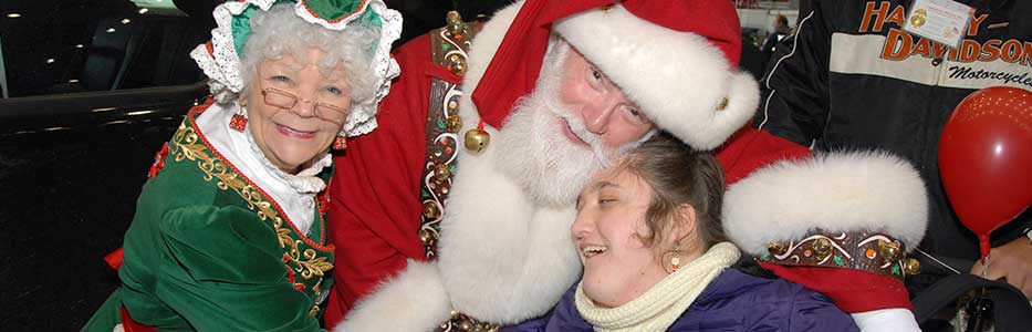 Santa and Mrs. Claus with teen at Operation Santa Claus